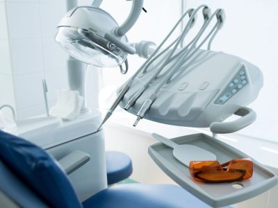 Clean professional design of working machines of dentist placed near client seat.